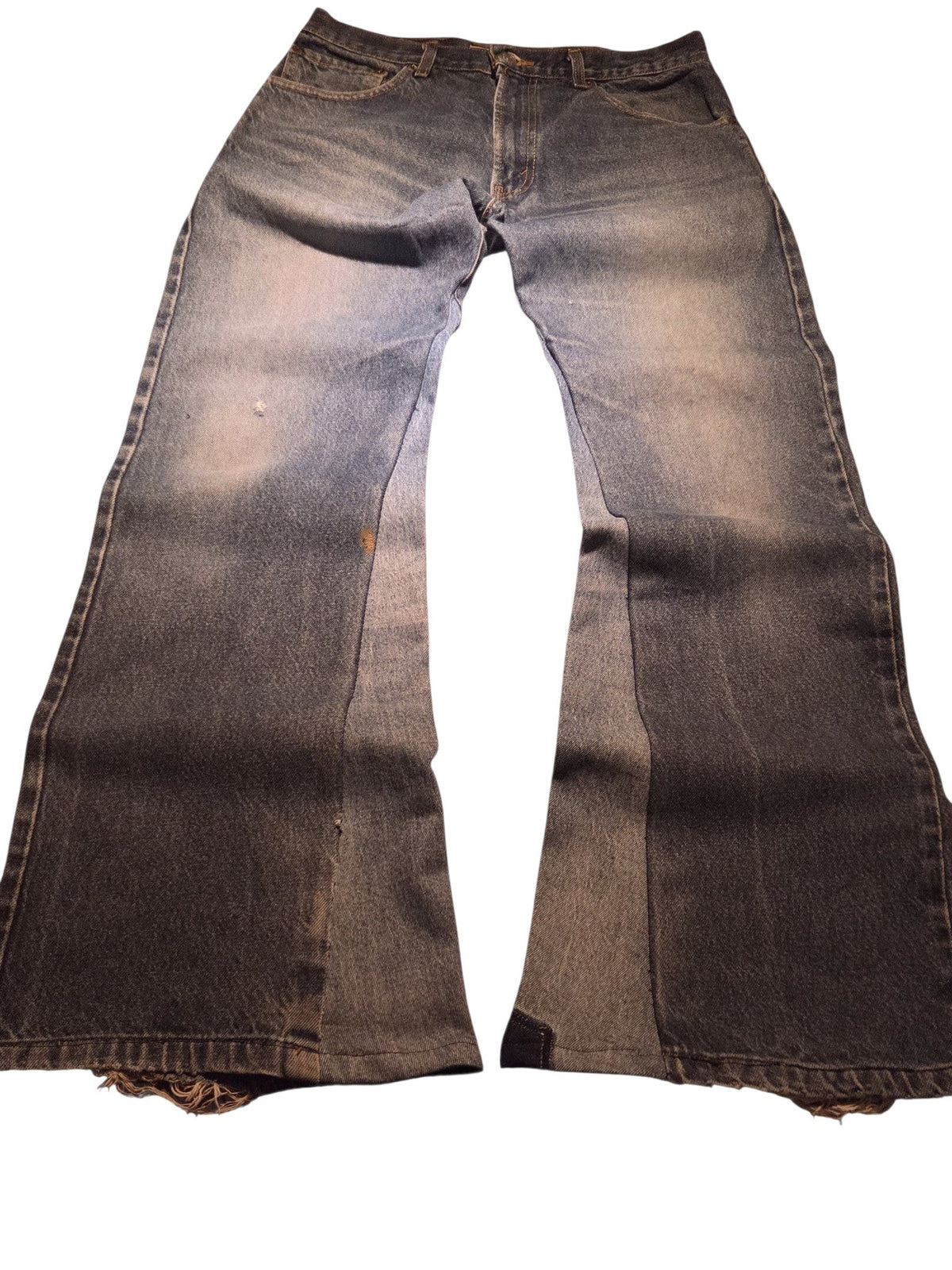 R3VIVED custom vintage Levi's 517 bootcut jeans in blue denim with wide leg openings and distressed hem details.