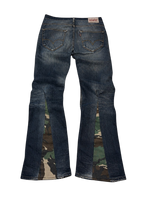 R3VIVED custom Levi bootcut jeans in blue denim featuring unique camo pattern flare inserts at the leg hems