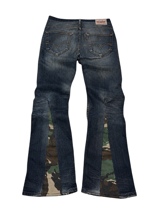 R3VIVED custom Levi bootcut jeans in blue denim featuring unique camo pattern flare inserts at the leg hems
